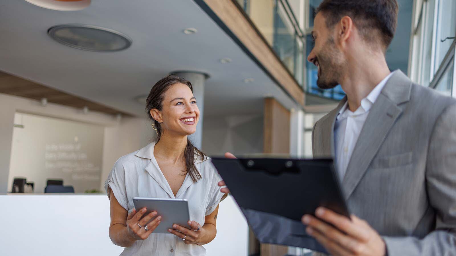 Office manager discussing a commercial cleaning quote in a modern Seattle office lobby