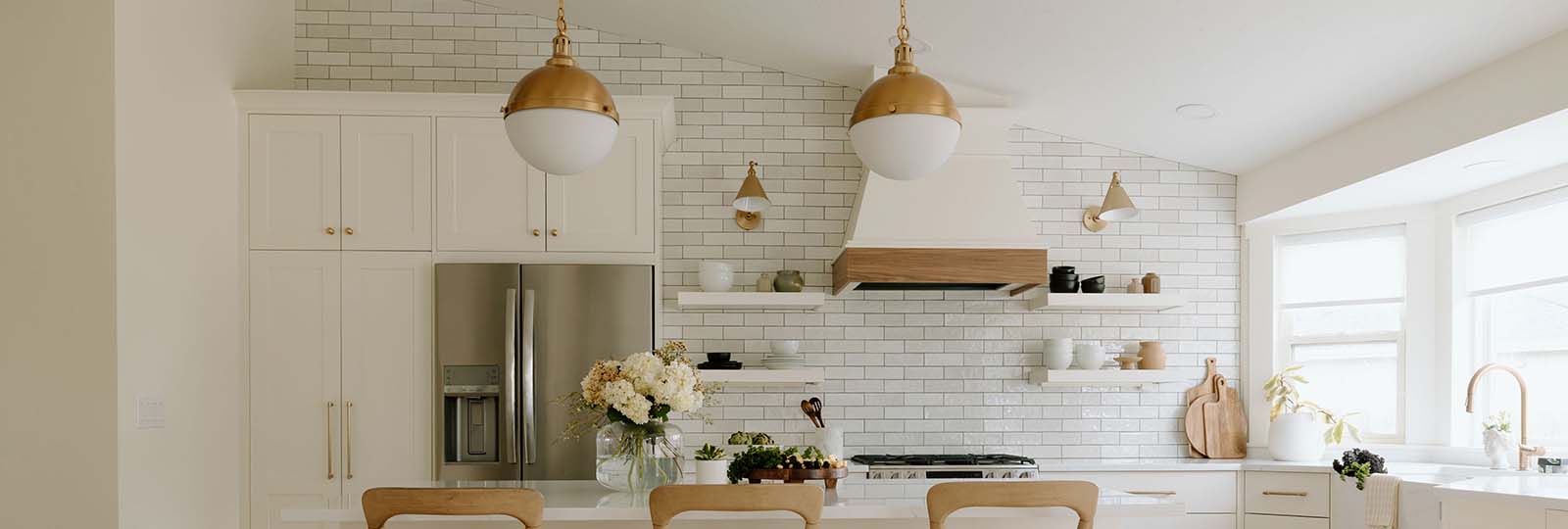 Newly renovated Seattle kitchen with white cabinetry, subway tile backsplash, and gold hardware — post-remodel cleaning by Simply Clean