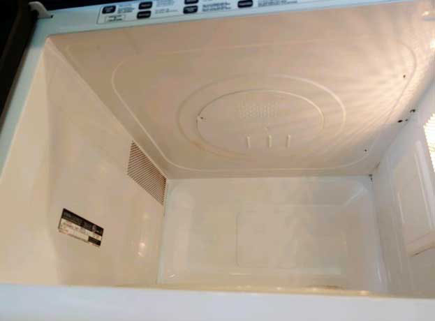 Spotless and shiny microwave interior with a bright white surface after professional deep cleaning in Bellevue.