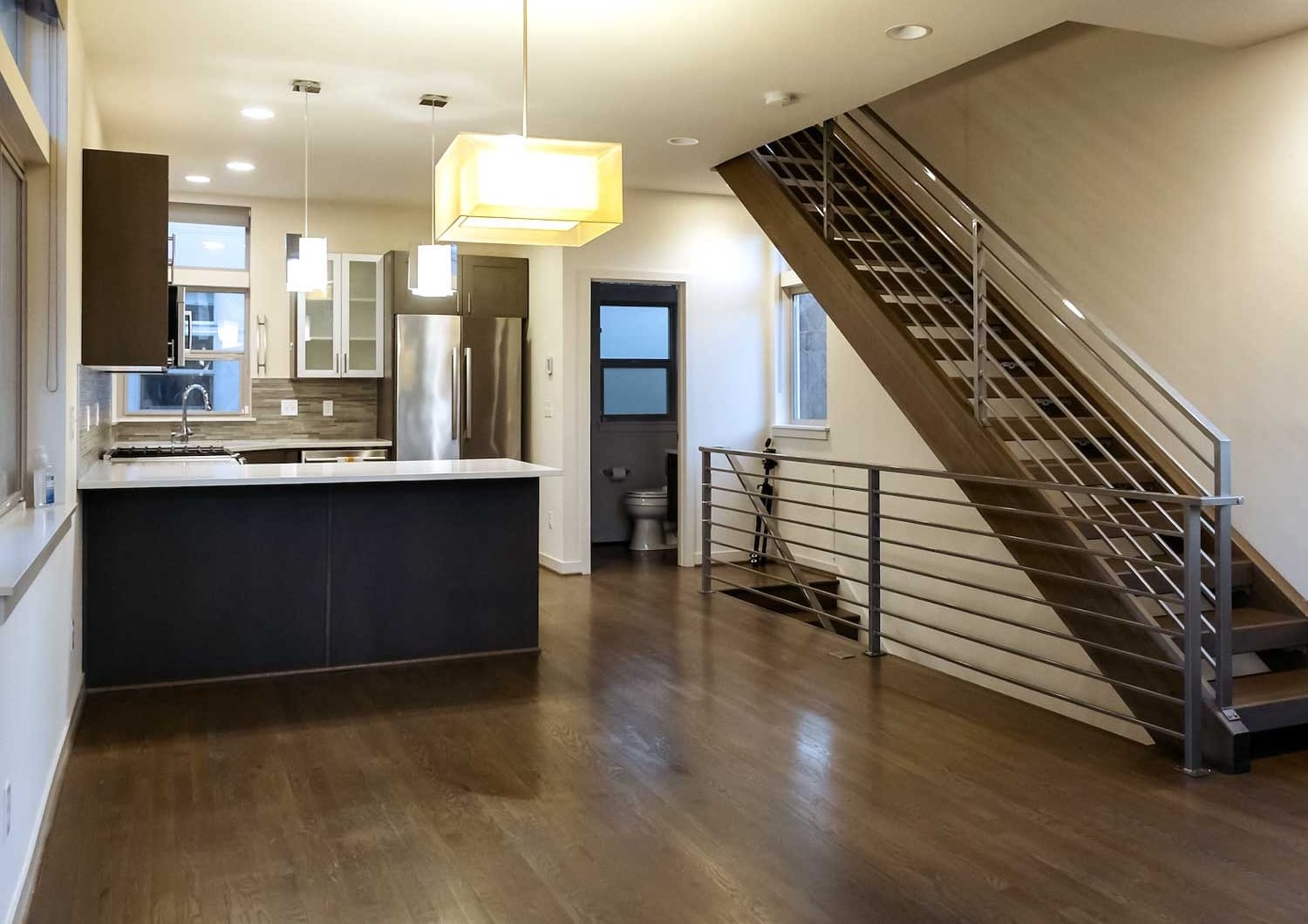 After image of a fully cleaned Ballard Seattle tri-level townhouse showing polished floors, sanitized kitchen counters, and a tidy modern living room after professional move-out cleaning.