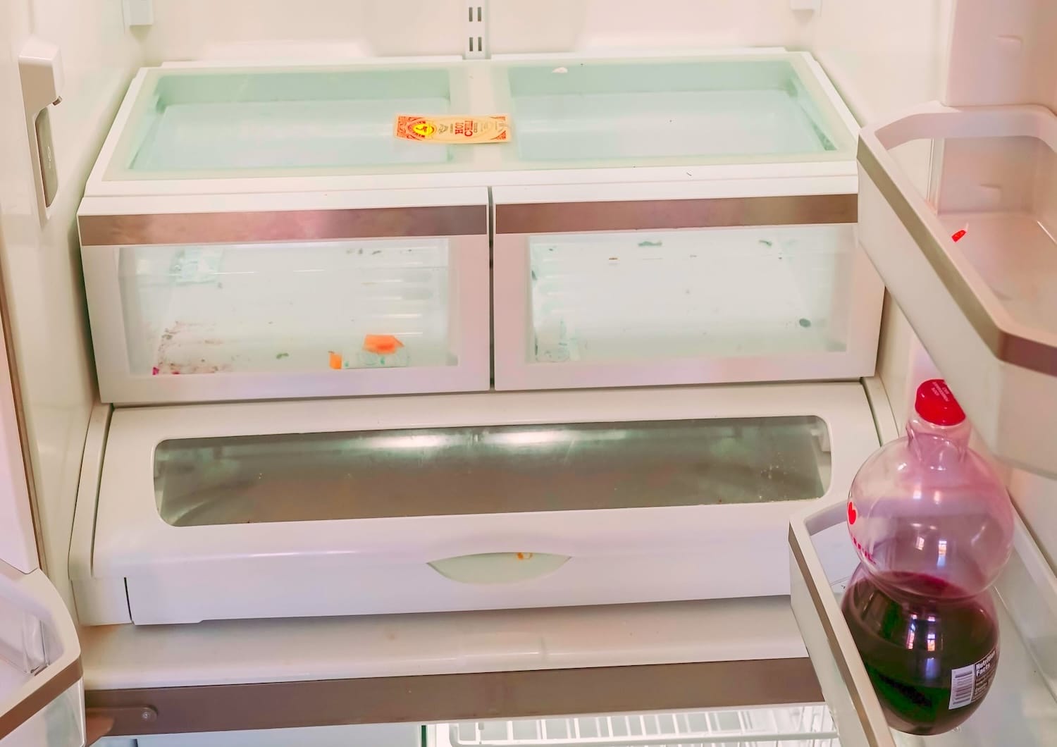 Before image of refrigerator interior with stains and food residue, part of Seattle kitchen deep cleaning by Simply Clean.