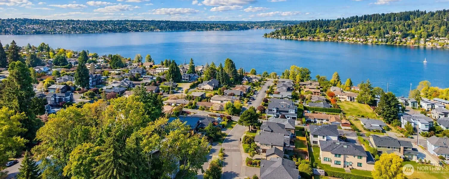 Aerial view of Renton homes on a hillside above the south end of Lake Washington on a sunny day