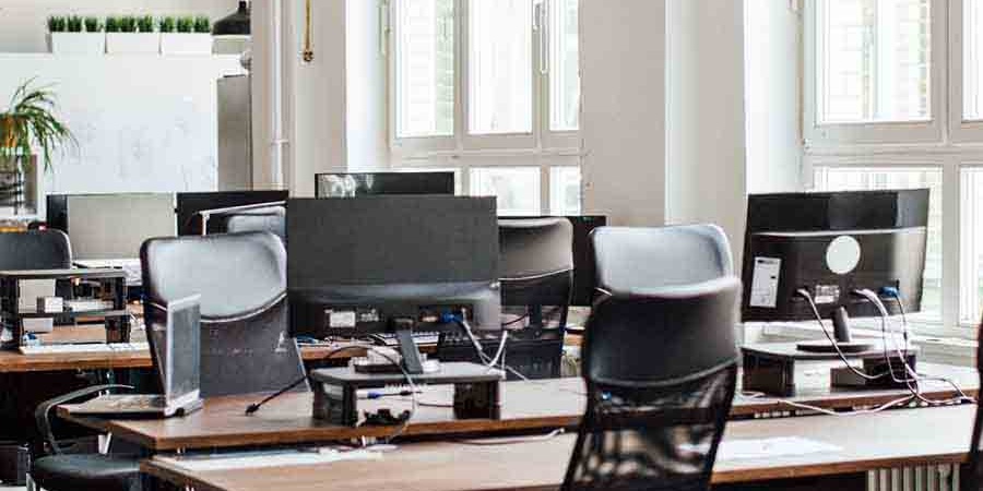 Modern technology office workspace with organized desks and computer equipment, maintained with professional office cleaning services in Seattle