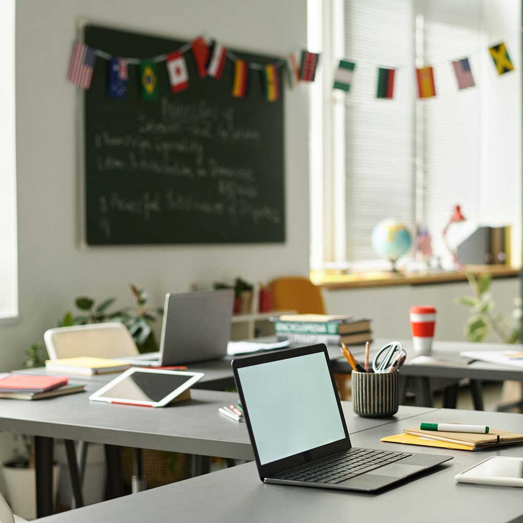 Clean, organized learning center classroom in Seattle with neatly arranged desks, laptops, and writing materials