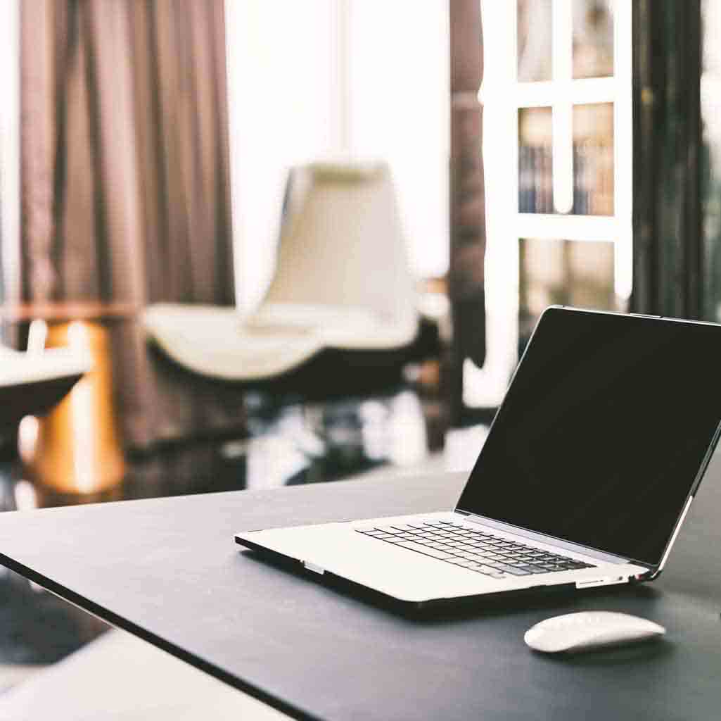 Clean executive office workspace in Seattle with modern desk setup and seating area