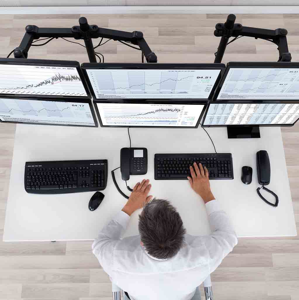 Organized financial office workstation in Seattle with multiple monitors and clean desk layout