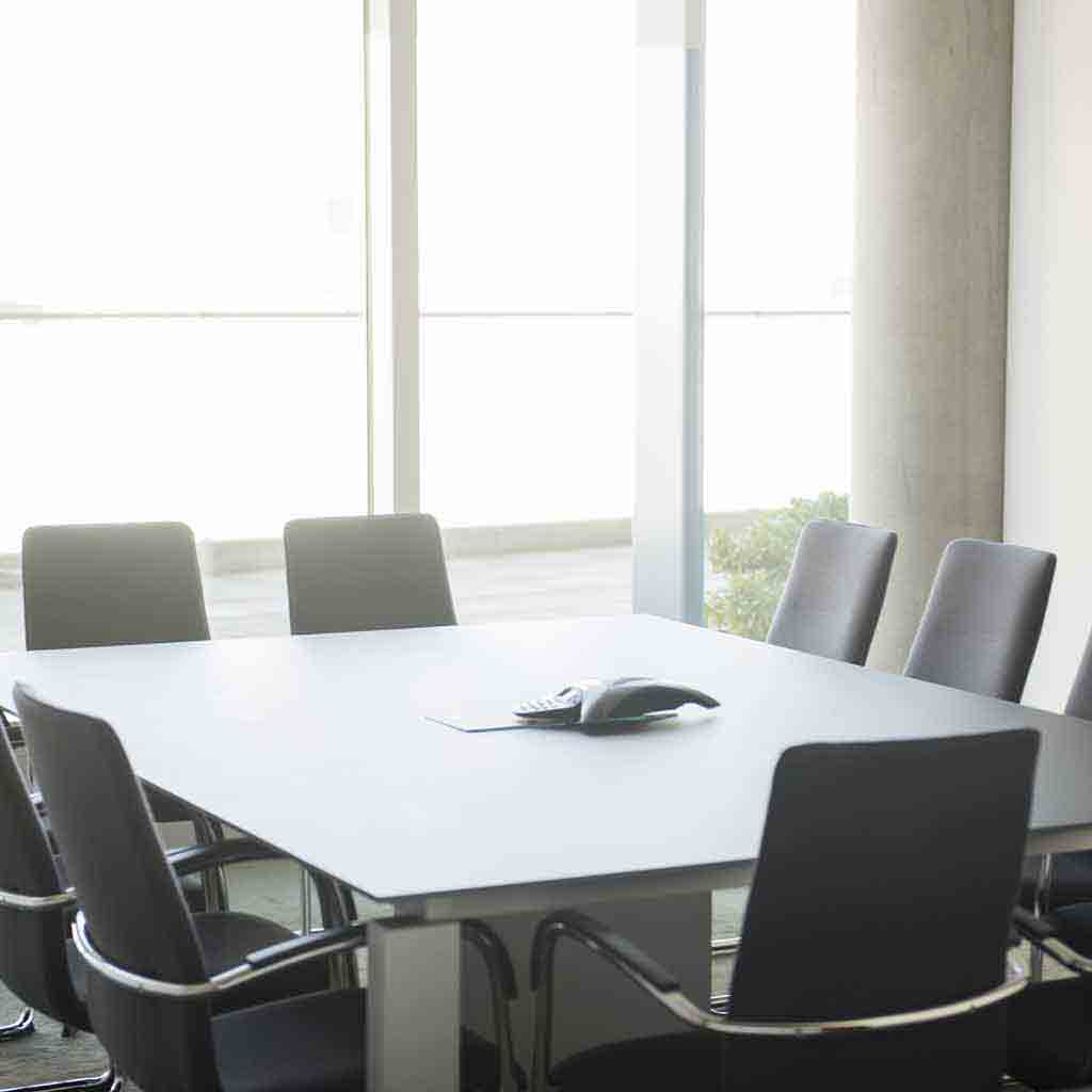 Clean nonprofit boardroom with conference table and meeting chairs in a professional office environment