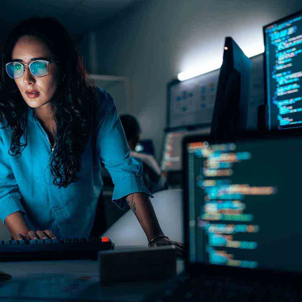 Quiet engineering office with clean desks, computer monitors, and a focused workspace layout in a modern technology environment