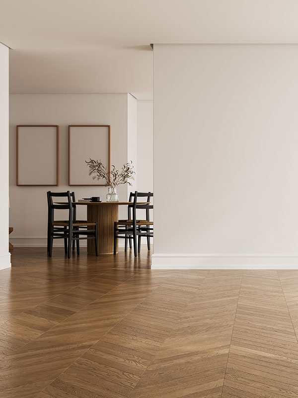 Minimalist dining area with wooden herringbone floor, round table, black chairs, and neutral decor in Seattle by Simply Clean