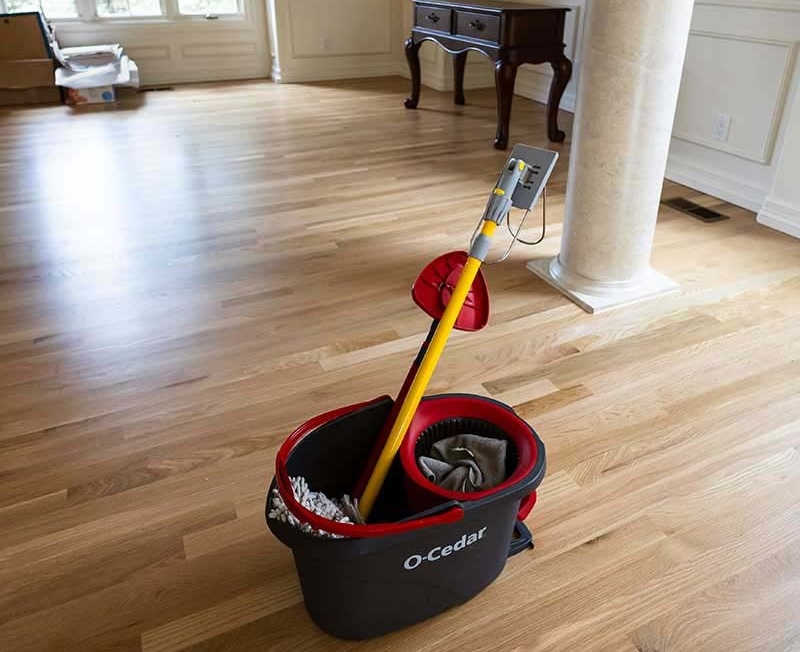 Large living room with limestone columns and gleaming hardwood floors after professional move-out cleaning in Seattle by Simply Clean — prepared for final inspection and key handover