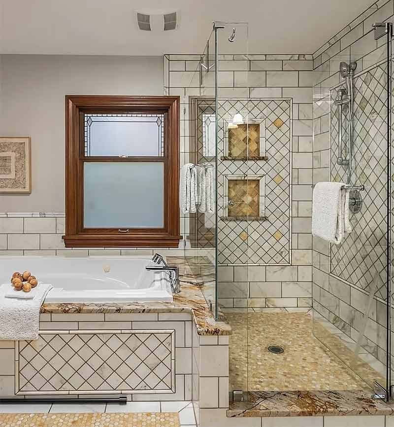 Clean master bathroom in a Seattle home after a deep cleaning service — glass shower enclosure, soaker tub, and PNW evergreen view through the window