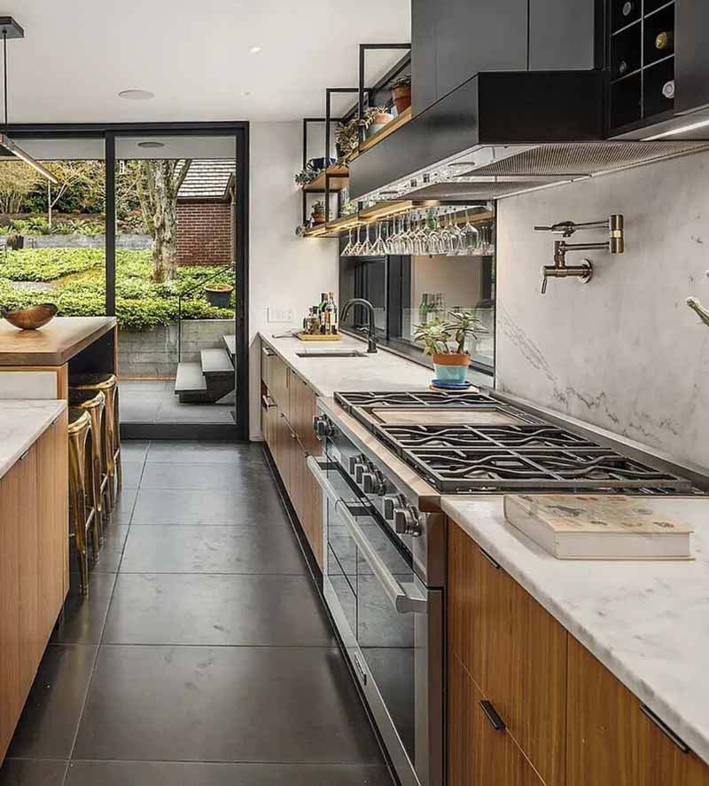 Clean craftsman kitchen in a Seattle home after a deep cleaning service — white quartz countertops, coffered ceiling, and Seattle hills through the window