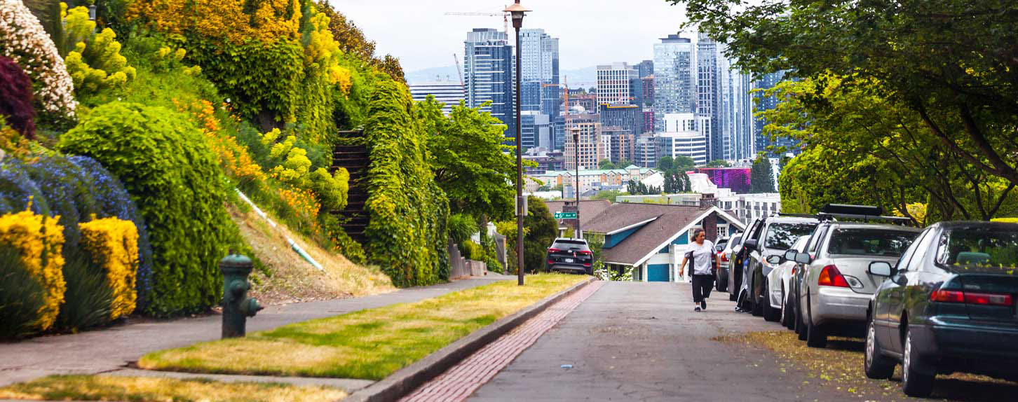 Image of Queen Anne neighborhood street with homes and a clear view of downtown Seattle. Used on the Simply Clean Service Areas page to illustrate the local Seattle neighborhoods served, including Queen Anne, Upper Queen Anne, Lower Queen Anne, Fremont, Ballard, Wallingford, Magnolia, and Capitol Hill.